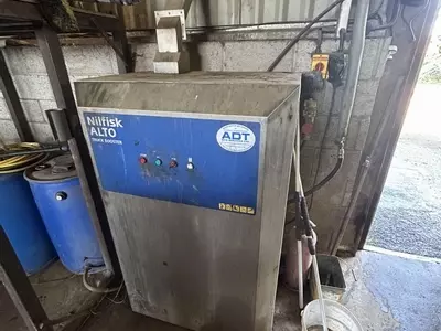 Nilfisk SH Truck Booster pressure washer prior to service, showing unit before pump overhaul after 8 years without maintenance.